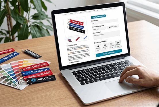 Customer selecting custom flight tags and uploading artwork on a laptop